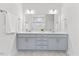 Bathroom featuring double sinks, a large mirror, and soft blue vanity at 857 Whistable Ave, Wake Forest, NC 27587