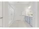 Bathroom with blue vanity, double sinks, glass enclosed shower and marble floors at 857 Whistable Ave, Wake Forest, NC 27587