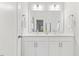 Bathroom featuring a double sink vanity, mirror, and white cabinets at 857 Whistable Ave, Wake Forest, NC 27587
