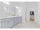 Elegant bathroom with double vanity, modern fixtures, and a glass-enclosed shower at 857 Whistable Ave, Wake Forest, NC 27587