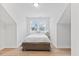 Neutral bedroom featuring hardwood floors, a queen bed, and a window at 857 Whistable Ave, Wake Forest, NC 27587