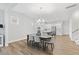 Open concept dining area with seating for six, leading to a bright and modern kitchen at 857 Whistable Ave, Wake Forest, NC 27587