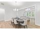 Dining room with chandelier and seating for six, next to a cozy living room with coffered ceilings at 857 Whistable Ave, Wake Forest, NC 27587
