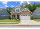 Charming brick home with a well-maintained lawn and a two-car garage, a perfect blend of style and functionality at 857 Whistable Ave, Wake Forest, NC 27587