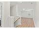 Bright hallway with hardwood floors, natural light, and stairs at 857 Whistable Ave, Wake Forest, NC 27587
