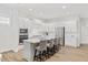 Modern, all-white kitchen with a large island and bar stool seating, perfect for entertaining at 857 Whistable Ave, Wake Forest, NC 27587