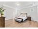 Spacious main bedroom with wood floors, tray ceiling, and bench seating at the foot of the bed at 857 Whistable Ave, Wake Forest, NC 27587