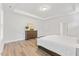 Bright main bedroom with tray ceilings, wood floors, and a large dresser at 857 Whistable Ave, Wake Forest, NC 27587