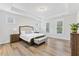 Spacious main bedroom with natural light, hardwood floors, and a calming, neutral color palette at 857 Whistable Ave, Wake Forest, NC 27587