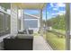 Cozy screened-in porch with comfortable seating, perfect for enjoying the outdoor views at 857 Whistable Ave, Wake Forest, NC 27587