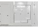 Modern all-white shower with glass enclosure and seating at 857 Whistable Ave, Wake Forest, NC 27587