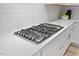 Close-up of a gas stovetop with white countertop at 857 Whistable Ave, Wake Forest, NC 27587