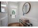 Bright entryway featuring board and batten detail, hardwood floors and a round mirror at 90 Merle Way, Wendell, NC 27591