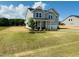 Two-story home with a two-car garage, inviting front porch, and professionally landscaped front yard at 90 Merle Way, Wendell, NC 27591