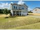 Classic two-story home with a welcoming front porch and beautiful landscaping at 90 Merle Way, Wendell, NC 27591