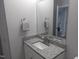 Bathroom featuring a granite countertop, white cabinet, and modern fixtures at 911 Washington St # 102, Raleigh, NC 27605