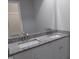 Bathroom featuring a double sink vanity with granite countertops and modern fixtures at 911 Washington St # 102, Raleigh, NC 27605