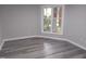 Neutral bedroom with gray walls, gray wood flooring, and one window offering a view at 911 Washington St # 102, Raleigh, NC 27605