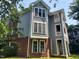 Charming multi-story home with gray siding, red brick accents, and multiple windows at 911 Washington St # 102, Raleigh, NC 27605