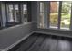 Cozy living room with large windows, gray walls, and stylish wood flooring at 911 Washington St # 102, Raleigh, NC 27605