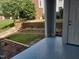 Covered front porch leading to a landscaped front yard with garden and walkway at 911 Washington St # 102, Raleigh, NC 27605