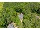 Aerial view of house nestled among lush trees, showcasing its serene setting at 100 Donald Dr, Pittsboro, NC 27312