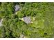 Aerial view of a home surrounded by lush greenery, showcasing the property's privacy at 100 Donald Dr, Pittsboro, NC 27312