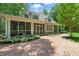Backyard with screened-in porch and a brick walkway, perfect for outdoor living at 100 Donald Dr, Pittsboro, NC 27312