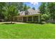 Spacious backyard featuring a covered porch and manicured lawn, perfect for outdoor living at 100 Donald Dr, Pittsboro, NC 27312