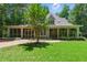 Charming home with a screened porch and brick walkway surrounded by lush landscaping at 100 Donald Dr, Pittsboro, NC 27312