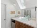 Bright bathroom featuring modern glass bowl sink and a skylight at 100 Donald Dr, Pittsboro, NC 27312