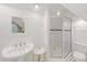 All-white bathroom with glass shower, stand alone sink, and natural light at 100 Donald Dr, Pittsboro, NC 27312