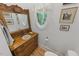 Charming powder room featuring a unique oval window and repurposed vanity at 100 Donald Dr, Pittsboro, NC 27312