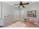 Bedroom with hardwood floors, ceiling fan, and a chest of drawers at 100 Donald Dr, Pittsboro, NC 27312