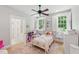 Bright bedroom with hardwood floors, ceiling fan, and bright shutters at 100 Donald Dr, Pittsboro, NC 27312