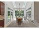 Bright sunroom dining area with multiple windows and skylights, perfect for enjoying natural light at 100 Donald Dr, Pittsboro, NC 27312