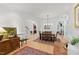 Open-concept dining area with wood floors and stylish lighting fixture at 100 Donald Dr, Pittsboro, NC 27312