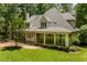 Beautiful home features a screened-in porch, landscaping, and a manicured lawn at 100 Donald Dr, Pittsboro, NC 27312