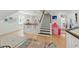 Bright foyer with hardwood floors, white staircase, and a pink tent at 100 Donald Dr, Pittsboro, NC 27312