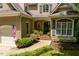 Charming home entrance with brick steps and landscaped garden at 100 Donald Dr, Pittsboro, NC 27312