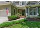 Home's lovely front entrance with a brick pathway and manicured landscaping at 100 Donald Dr, Pittsboro, NC 27312