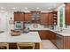 Gourmet kitchen features stainless steel appliances, wood cabinets, marble countertops, and a large island at 100 Donald Dr, Pittsboro, NC 27312