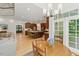 View of the dining area and kitchen with center island, stainless steel appliances and hardwood flooring at 100 Donald Dr, Pittsboro, NC 27312