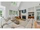 Cozy living room featuring vaulted ceilings, fireplace and many windows at 100 Donald Dr, Pittsboro, NC 27312