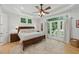 Tranquil main bedroom with a ceiling fan, en-suite bathroom, and French doors to the outdoors at 100 Donald Dr, Pittsboro, NC 27312