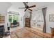 Office with built-in shelves, large window, French doors, and a ceiling fan at 100 Donald Dr, Pittsboro, NC 27312