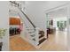 Elegant staircase with wooden treads and white risers connects the home's levels at 100 Donald Dr, Pittsboro, NC 27312