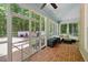 Bright sunroom with brick flooring, screened windows, and outdoor patio access at 100 Donald Dr, Pittsboro, NC 27312