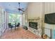 Beautiful sunroom featuring a stone fireplace and access to the screened-in porch at 100 Donald Dr, Pittsboro, NC 27312