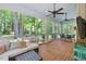 Cozy sunroom with brick flooring and panoramic views of the surrounding greenery at 100 Donald Dr, Pittsboro, NC 27312